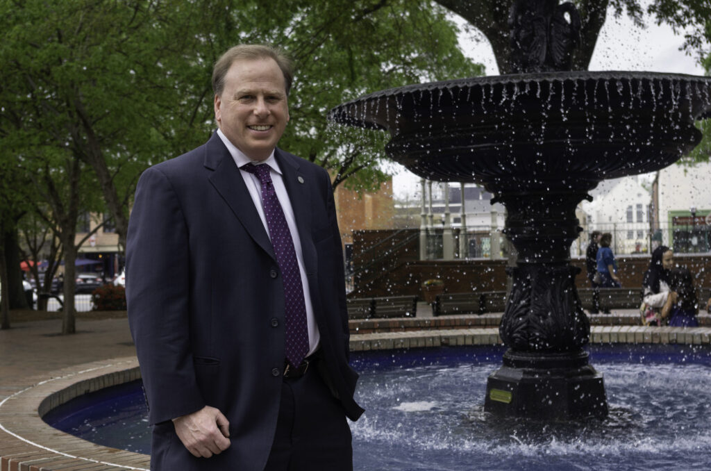 Portrait of Gerald Moore standing in front of a water fountain in Cobb County